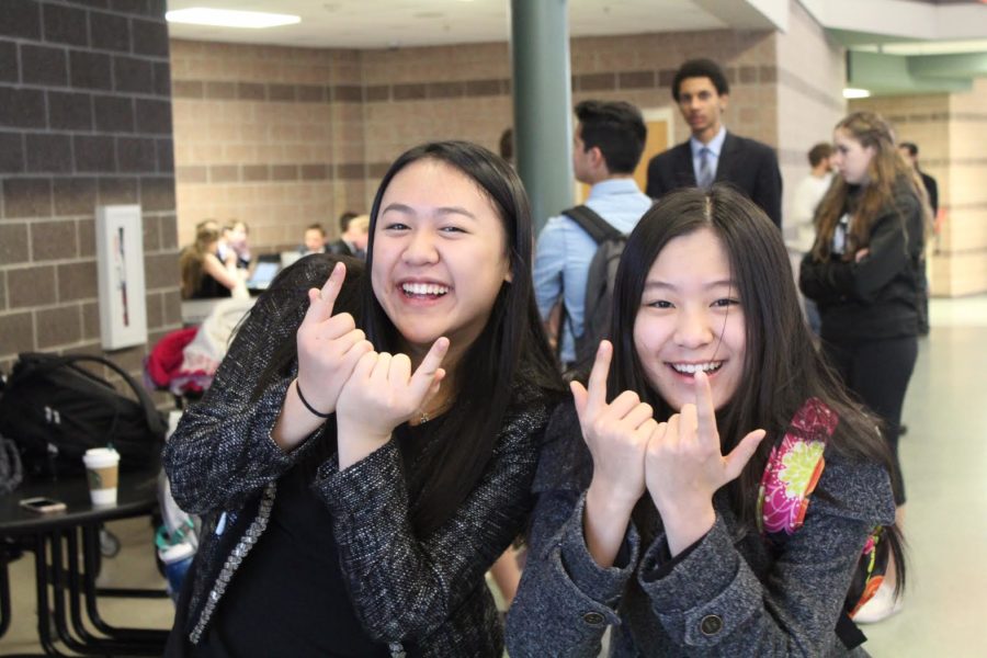 Emily Huang and Annie Chang mess around before the first debate round begins.