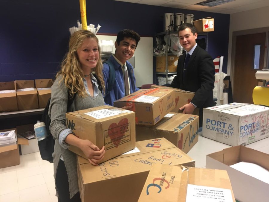 Junior Brooke Schmidt, Senior Max Gomez, and Sophomore Taid Zdinak finish packing boxes of supplies to send to students affected by Hurricane Harvey in Houston.