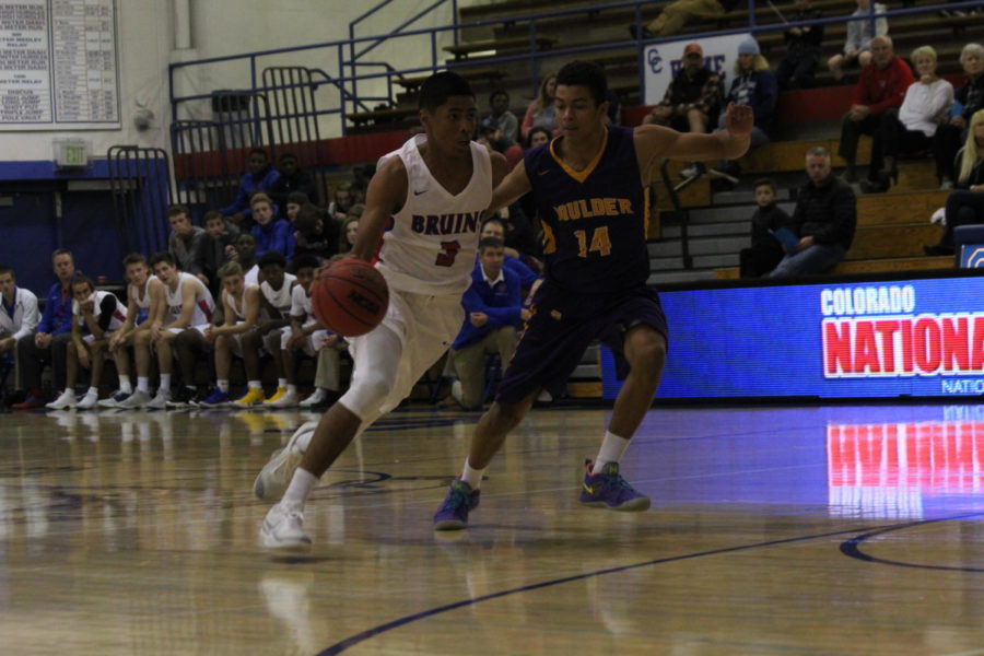ON POINT: Sophomore point guard Julian Hammond drives to the basket during the first game of the season against Boulder on Dec. 4. Creek won 73-49. Hammond, although hes a sophomore, is a key player and starter for the team.