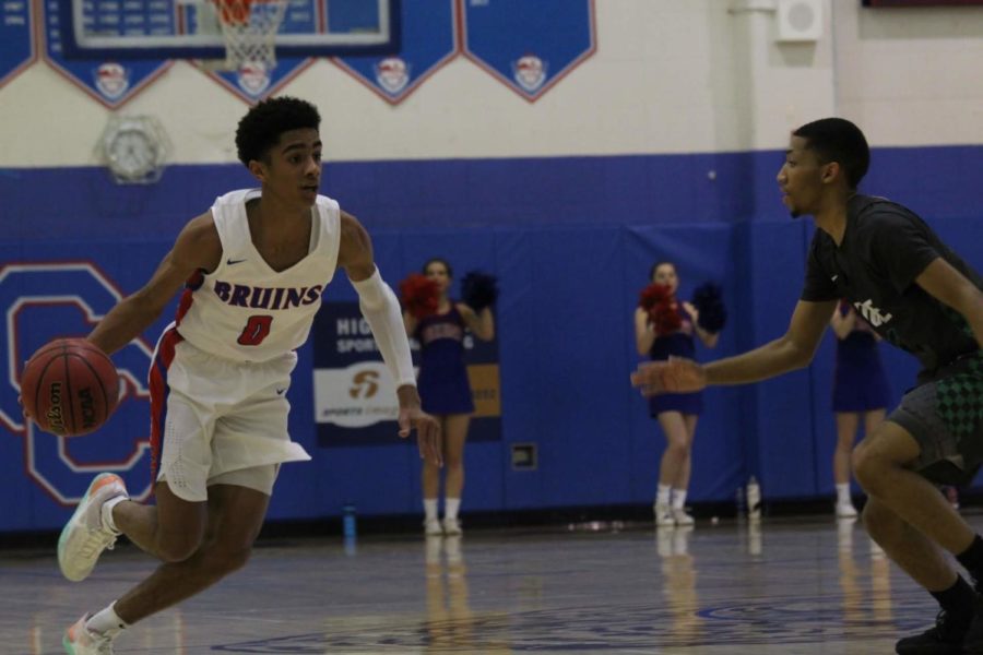 Junior Sebastian Cole drives the ball down the court.