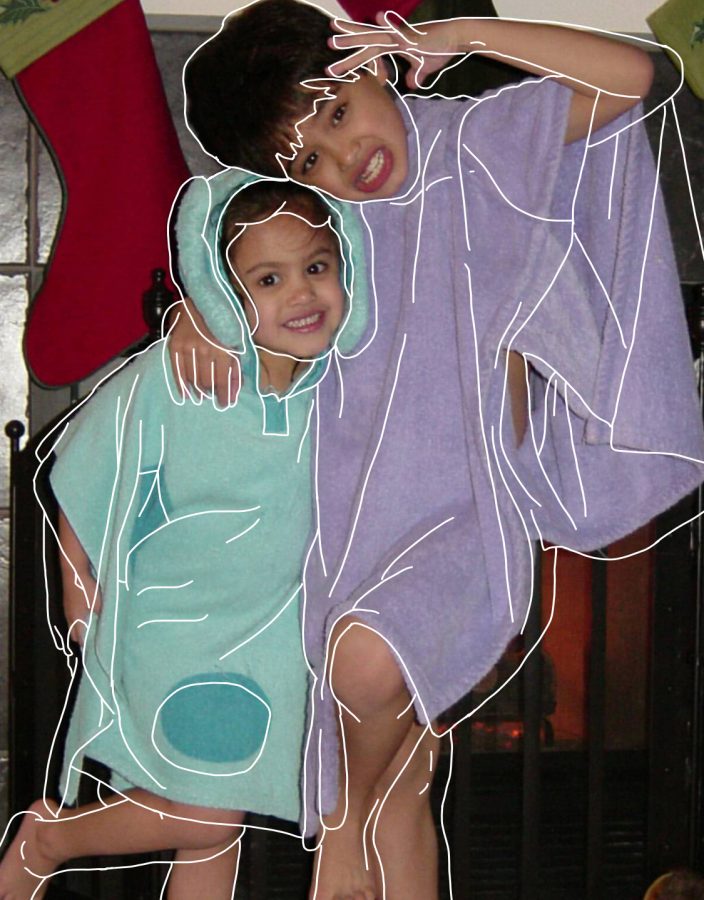 Senior Faith McCurdy and her brother 13 years ago at their childhood home on Christmas Eve. Every year, as a “McCurdy tradition,” they would sit in front of the fire place listening to “This Christmas” by Donny Hathaway in their Blues Clues and Barney towels.