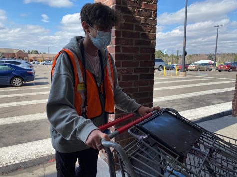 PUSHING CARTS: Courtesy Clerk Mazin Klapperich brings in carts at King Soopers store 096. On the busiest days, such as Sundays, clerks bring in up to 15 carts at a time. Klapperich also expressed sorrow for those killed at the Boulder King Soopers on Mar. 22.