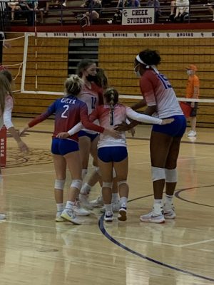 Creek celebrates after scoring a point on Broomfield during their 25-19 win. Creek went a perfect 4-0 during the September 11 tournament at Cherry Creek High School to improve to a perfect 9-0.