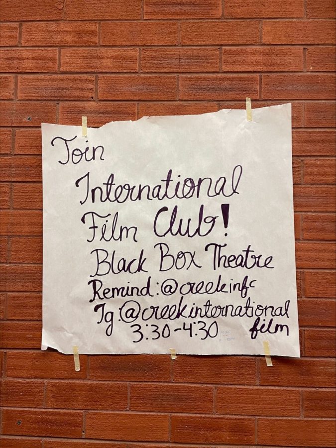 One of the several handwritten posters hung around school sits advertising club information. 