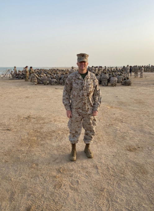 A Strong Representative: Clark stands proudly on Qatari soil in front of a military exercise. This was one of the many exercises during Clarks deployment to the Middle East in 2019. Clark was asked (last minute) to fill the shoes as Qatars representative to his general. He handled all of the logistics for the Marine Corps and worked in the U.S. Embassy in Doha (in the office of military cooperation). Clark was also able to explore the country culturally and even saw the World Cup being set up three years in advance. It was really a great experience to be a more well rounded officer, and I learned so much about the Middle East, Clark said.