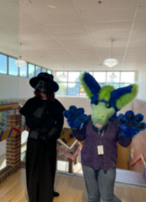 On Mon Oct 4, students dressed as their favorite movie character. Freshman Paige Mack (left) is dressed in her outlandish outfit based on the movie and video game character SCP-049; sophomore Annie Bellini (right) is dressed in her handmade fursuit based on her own original character. The friends relax at the library after a long day of posing for pictures. “Lots of people wanted photos, its fun,” Bellini said. “I was just really excited for everything [spirit week], since I got to dress up and be myself.”