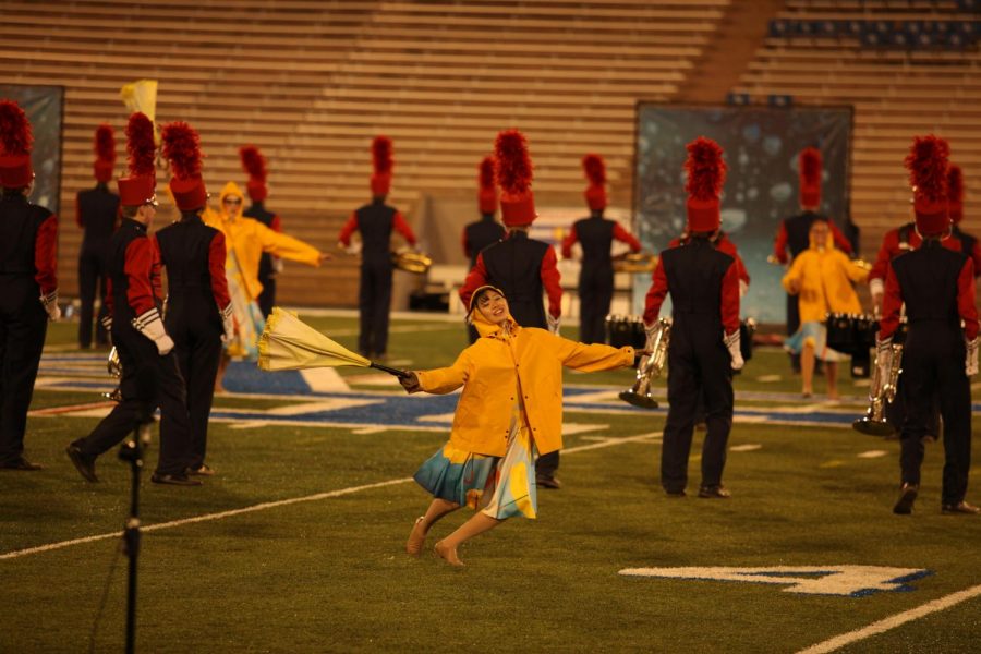 Junior+member+of+the+color+guard+Yuki+Ueta+dances+with+an+umbrella+during+the+first+part+of+Creeks+state+finals+performance.+This+years+routine+was+titled+Rain%2C+and+the+songs+and+color+guard+costumes+were+rain-themed.+Creek+did+better+than+expected+and+better+than+ever+before+at+the+state+and+regional+level+this+season%2C+with+an+all-time+high+score+of+83+in+the+state+competition.+%E2%80%9CThis+is+the+first+time+since+1991%2C+and+possibly+in+band+history%2C+that+we+have+ever+scored+this+high%2C%E2%80%9D+junior+trombonist+Rachel+Novak+said.+%E2%80%9CWe%E2%80%99ve+placed+third+before%2C+but+we+have+never+scored+an+83+before.%E2%80%9D