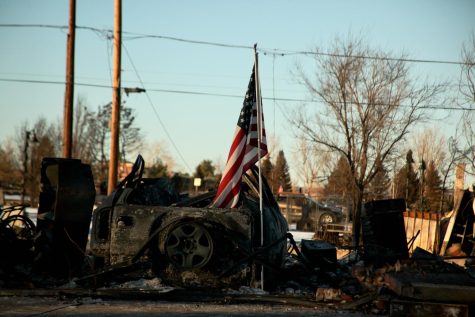 An American flag stands on a burned property in Old Town Superior. The Old Town neighborhood was among a few burned entirely to the ground in Superior and Louisville, Colorado, in the Marshall Fire, which swept Boulder County Dec. 30.
