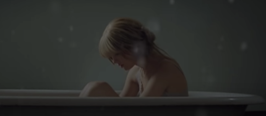 A scene from the Back To December music video that shows Swifts pain and regret expressed throughout the song.