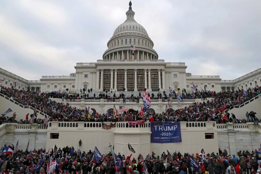 Right-wing extremists stand near the United States Capitol on Jan. 6, 2021, showing the spirit of sedition with flags and gallows that I believe aptly represent what happened to the future of the country that day one year ago. 