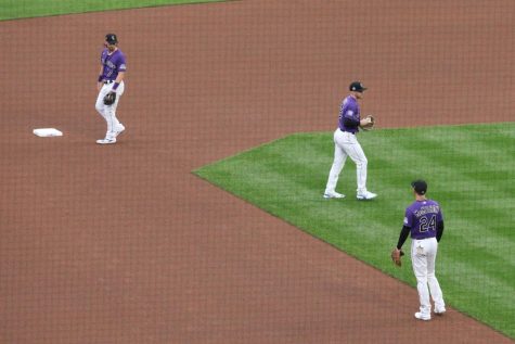 Rockies infielders Brendan Rodgers, Trevor Story, and Ryan McMahon warm up before a home game against the Chicago Cubs on Aug. 3, 2021. The Rockies failed to re-sign Story in the offseason, but did re-sign McMahon and kept Rodgers. 