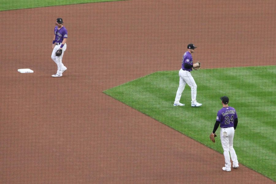 Rockies infielders Brendan Rodgers, Trevor Story, and Ryan McMahon warm up before a home game against the Chicago Cubs on Aug. 3, 2021. The Rockies failed to re-sign Story in the offseason, but did re-sign McMahon and kept Rodgers. 