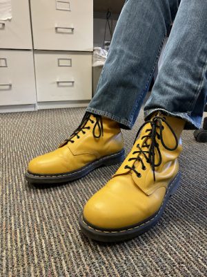  English teacher Joel Morris wears his yellow Dr. Martens. 
Because Morris has synesthesia, he associates colors with other topics such as the days of the week, yet he does not feel the need to color coordinate what he wears with those colors. “I dont feel like I need to color coordinate at all because its not really about [how] I have to match the color,” Morris said. “Its just that when I think of Monday, I think red.”
