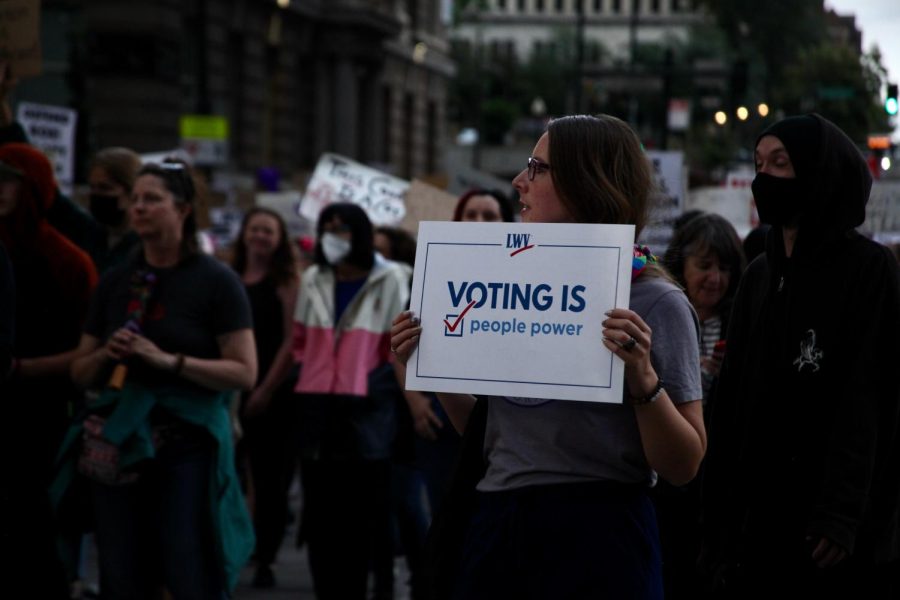 A+protester+holds+a+League+of+Women+Voters+sign+during+the+abortions+rights+protest+Friday.+The+LWV+national+convention+in+Denver+just+happened+to+coincide+with+the+overturning+of+Roe+v.+Wade%2C+but+national+secretary+Jessica+Rohloff+said+the+two+issues+were+intertwined.+Its+a+fight+for+human+dignity%2C+she+said.+And+if+we+can+approach+that%2C+and+if+we+can+approach+one+another+with+some+humility+and+understanding.