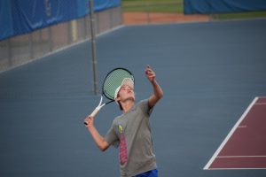 Freshman Adam Eikelberner serves the winning ball, beating Denver South. Breaking the tie resulting in a win for Creek. The game had been left in a tie after Creek lost three singles matches but won three doubles.