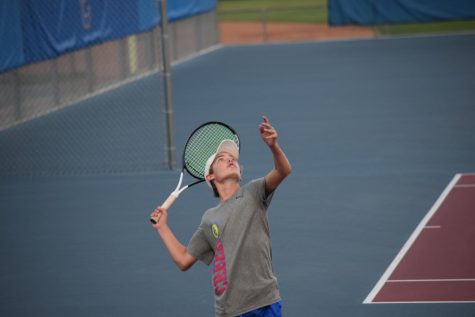 Freshman Adam Eikelberner serves the winning ball, beating Denver South. Breaking the tie resulting in a win for Creek. The game had been left in a tie after Creek lost three singles matches but won three doubles.