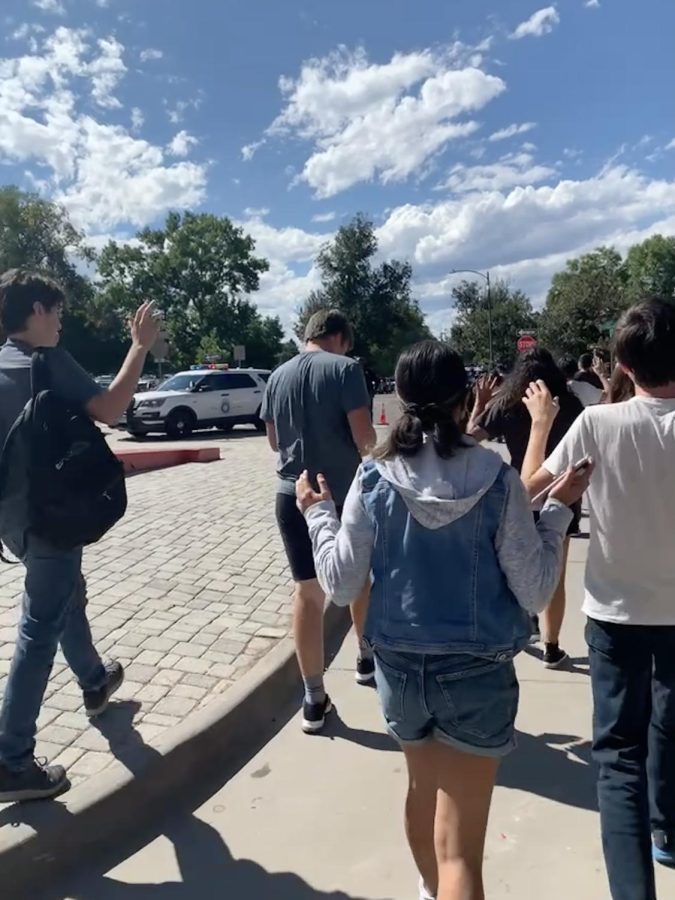 Students are escorted onto the football field after school lockdown.  “We were locked in the football field for about two hours in 90-degree heat, with no water or shade. At some point, firefighters were there and they were spraying us with their hose,” East Junior Deblasio said.