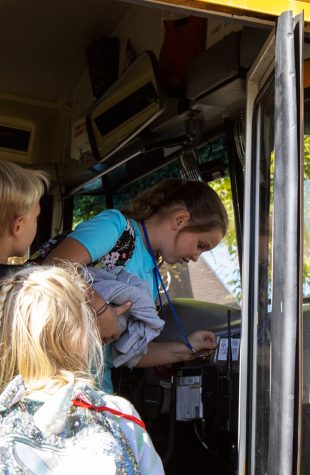 Belleview Elementary student Delaney Kregas scans her RFID card upon boarding her bus. Belleview implemented the card system earlier this school year to help transportation staff have an accurate count of how many students will be on the bus that day.