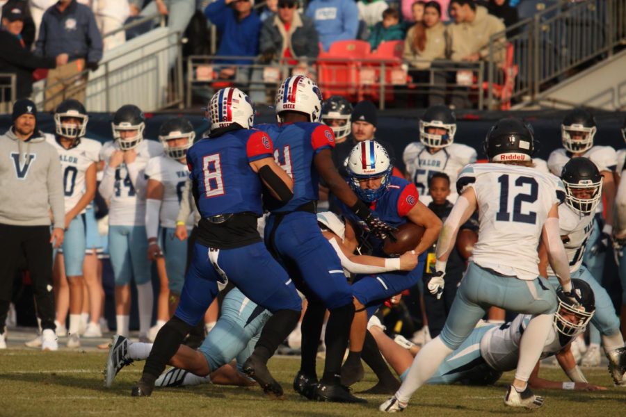 Senior wide receiver Cooper Pollard (#7) is tackled by a Valor player.