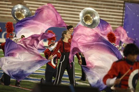 Senior color guard member Veronica Morarie performs during the state championship finals. Creek scored an 82.8, placing fourth. (Carly Philpott)