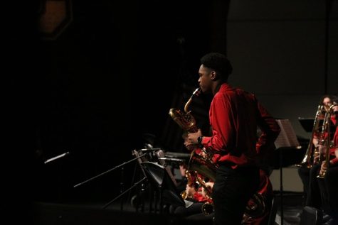 Junior Jazz B baritone saxophone Micah Davis performs a solo during the song 702 Shuffle. Because it was the bands third concert, more students performed solos than their first two concerts. 
