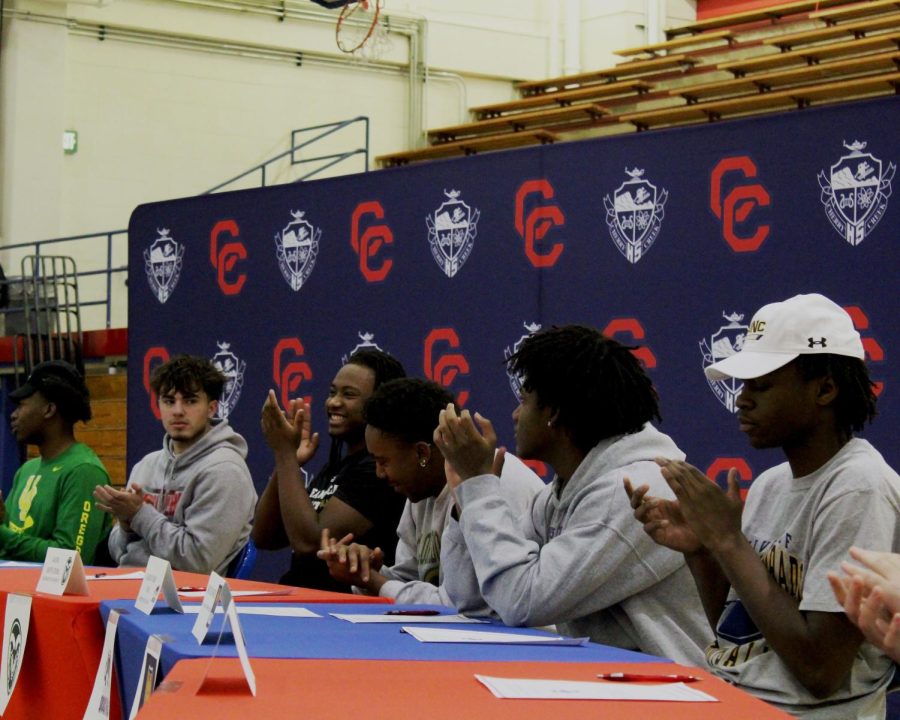 Senior football players celebrate signing to colleges on Feb. 1st, National Signing Day. All 13 players intend to pursue sports related majors in college.