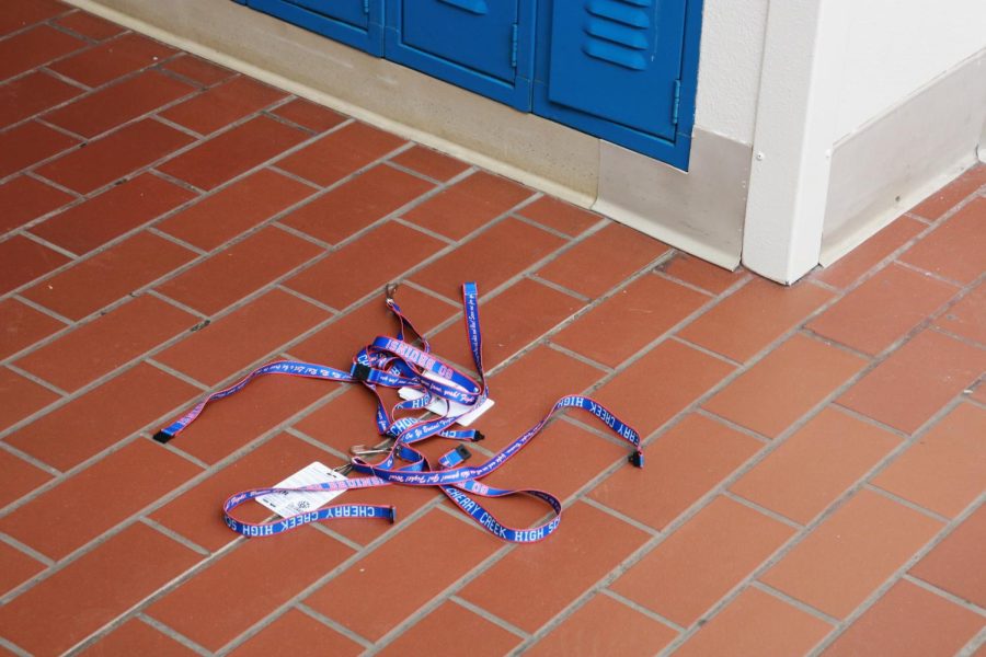Student ID lanyards are thrown on the floor, disregarded by faculty and students. 