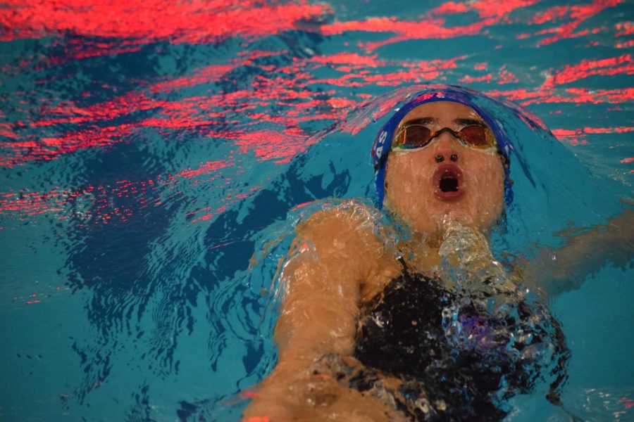 Senior varsity swimmer Lily Esmas competes against Cherokee Trail on Jan. 26 during the 100 yard backstroke event.