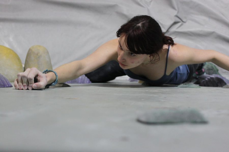 Junior Rose Chambers climbs a boulder problem at Rock’n and Jam’n, which closed Feb. 28. “So much of my life happened there,” Chambers said. “It’s really upsetting to have to let go of a place so important to me. It saw me grow up.”