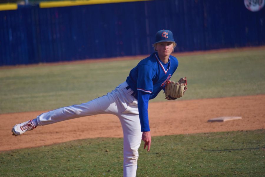 Junior Pitcher Cam Larson throws out a pitch during a game against Regis on March 23. Creek won the match 7-2.