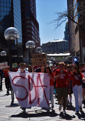 Members of Denver East High School Students Demand Action march down 16th Street Mall away from the Colorado Capitol on April 29. East students hosted the protest to advocate for gun legislation, joined by other Students Demand Action chapters and community members.