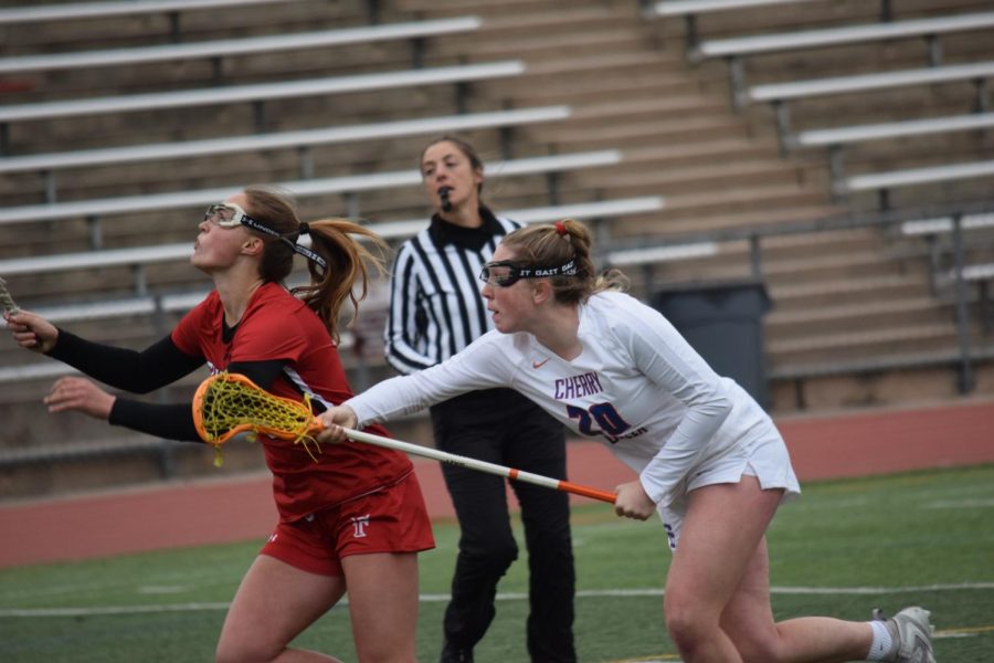 Girls%E2%80%99+varsity+lacrosse+sophomore+midfielder+Ava+Whitt+%28%2320%29+competes+during+a+game+against+Fairview+on+April+21.+Creek+won+the+match+12+-+9.