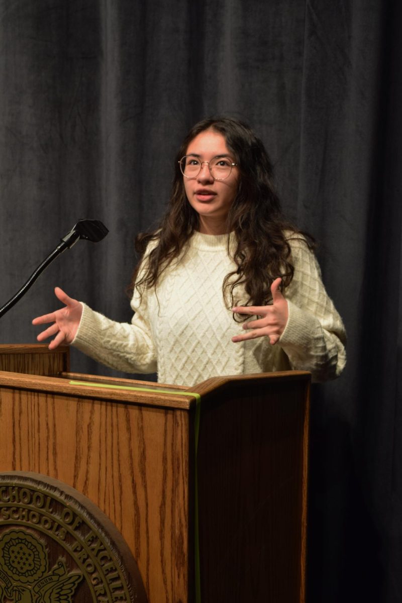 Senior Carissa Pomeroy poses behind a podium in the Fine Arts Theater. Pomeroy is working with the Colorado Youth Congress to fight for all-encompassing sex-ed in Colorado high schools.