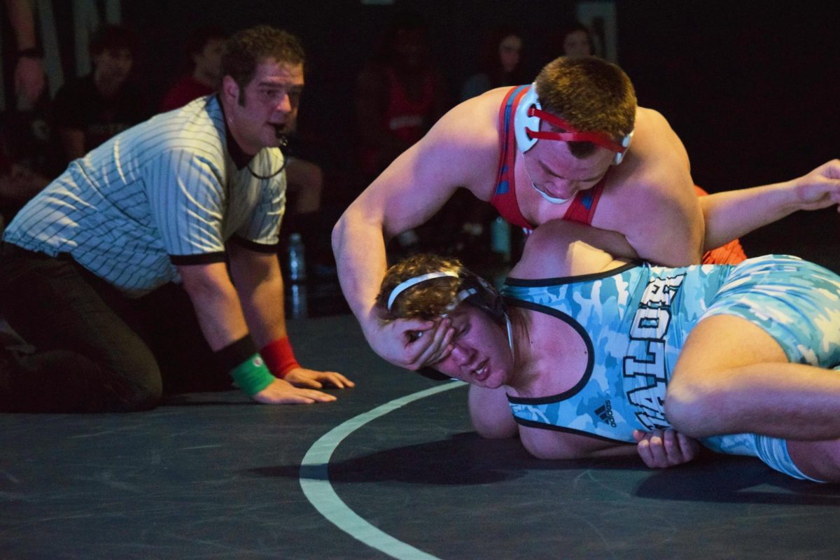 Senior Jake Howell tackles a Valor wrestler during a meet on Feb. 2. Howell won the match, but Creek lost 45-24.