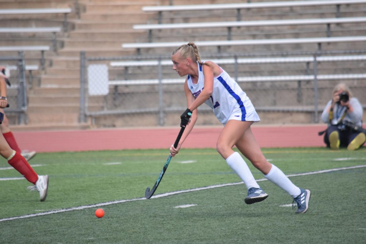 Sophomore middle Regan Talega (#2) moves the ball down the field during an Oct. 8 game against Kent Denver. 