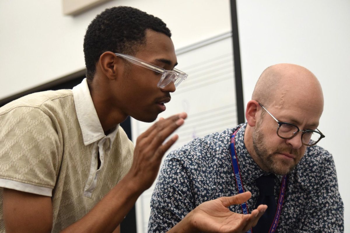 Walker(left) works with teacher Adam Cave on his piece after school. The two often work through structure and harmonies. 