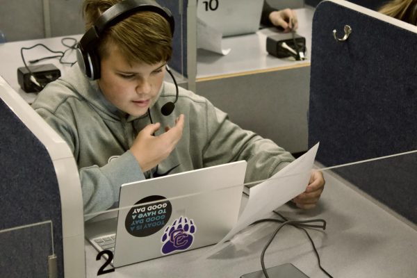 Freshman Ethan Berndt takes a practice speaking quiz in his CP German class. The new docking stations in the language lab allow students to connect to headphones, microphone, and audio software, all without the old desktop computers removed after last school year.