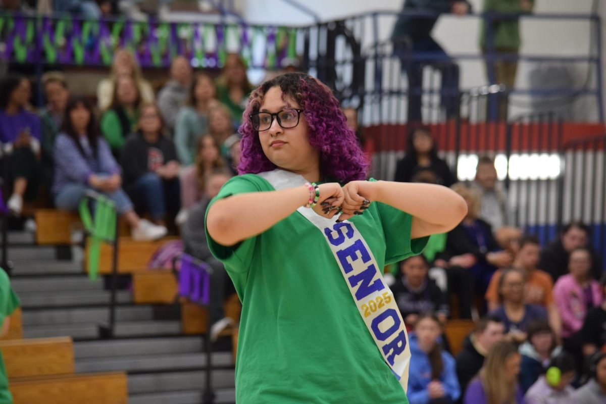 Senior and step team member Kai Alejo performs during Creek's spirit week assembly. 