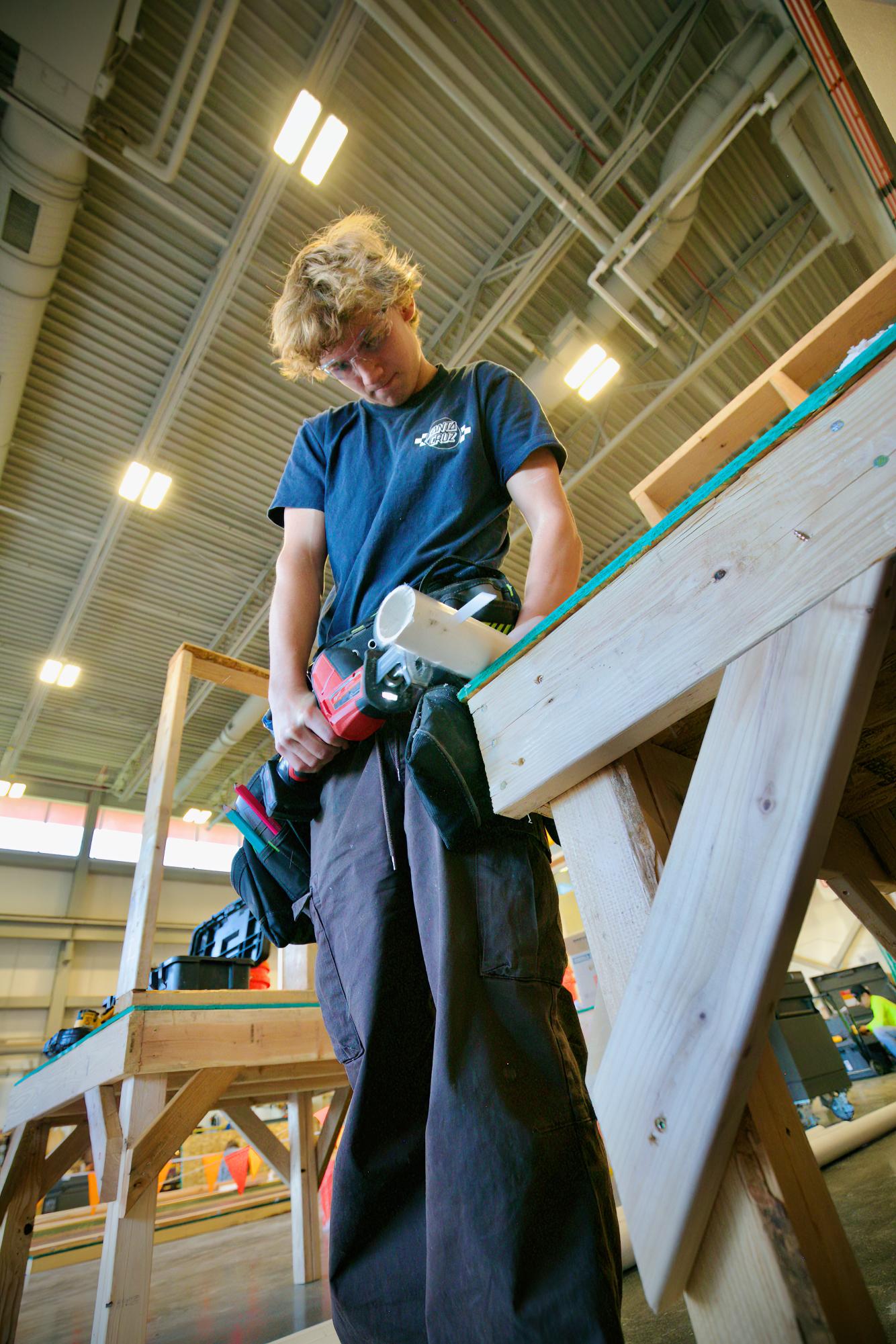 Creek junior Chris Tautz learns how to use a reciprocating saw on a piece of PVC pipe in CCIC’s Construction 1 class on Feb. 7. Tautz and other students in the class learn how to operate tools, and participate in building a house for Habitat For Humanity. For many students, opportunities like these allow them to develop career experience, and even earn certifications for future jobs. 