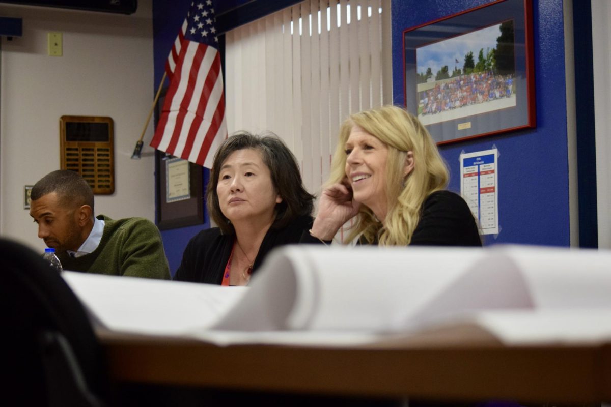 Project Leaders Jennifer Song-Keoppe (left) and Adele Wilson talk over ideas for the future athletics facilities with Athletics Director Jason Wilkins.