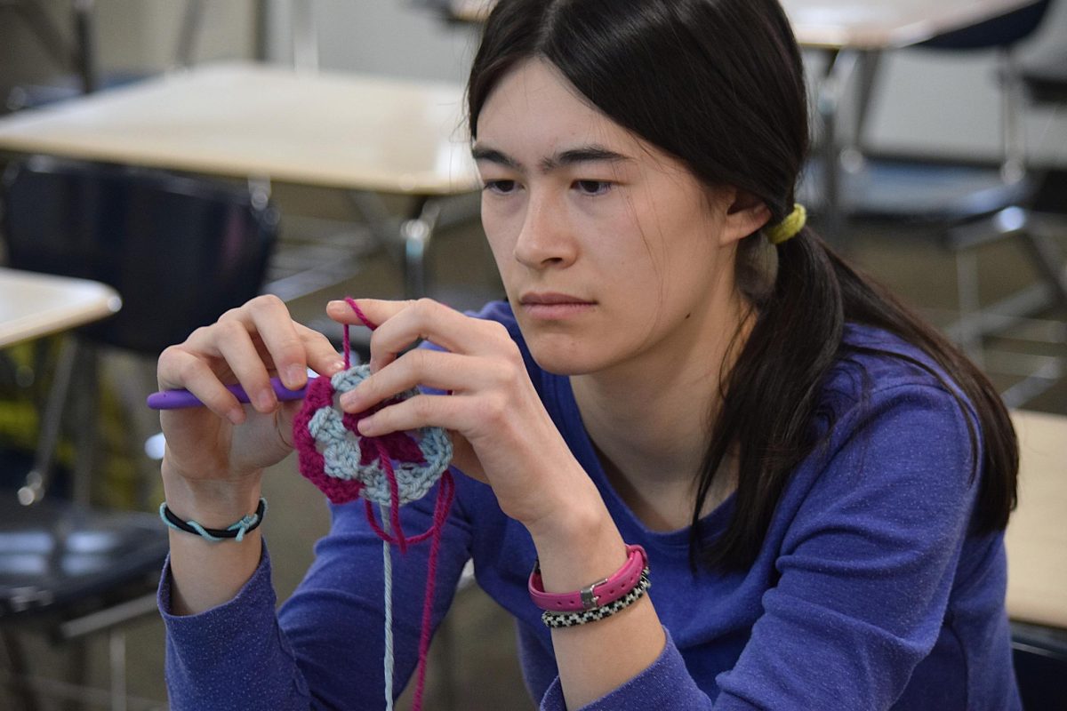 Senior Madeline Czaja works on a granny square in Crochet Club.