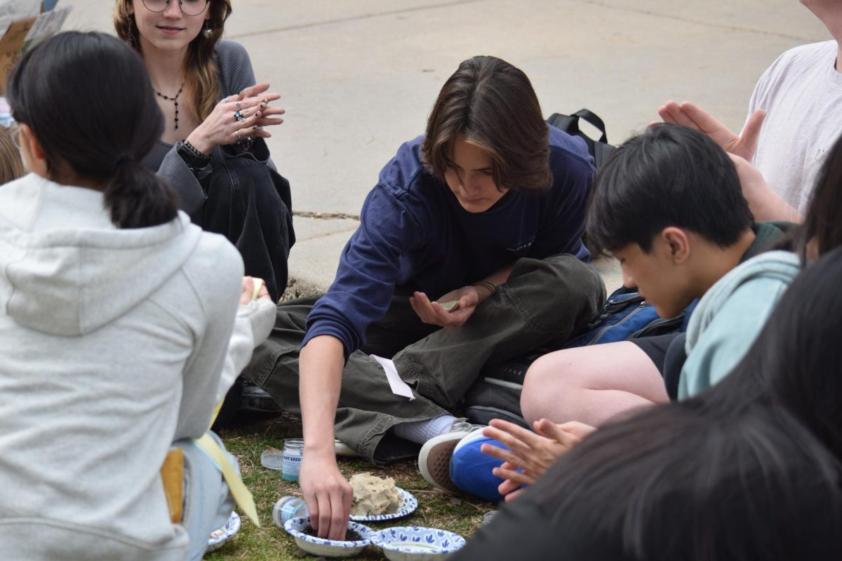 Junior Kaemon Vita forms a seed bomb at Key Club's seed bomb event. 