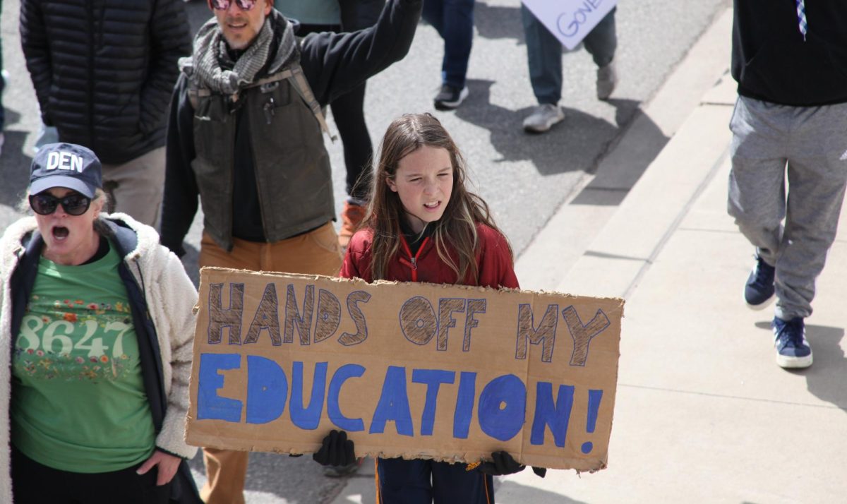 A young child holds a sign that reads “Hands Off My Education.” During Colorado’s ‘Hands Off’ protests against the Trump administration on April 5, many children could be seen protesting the actions being taken against the Department of Education. 