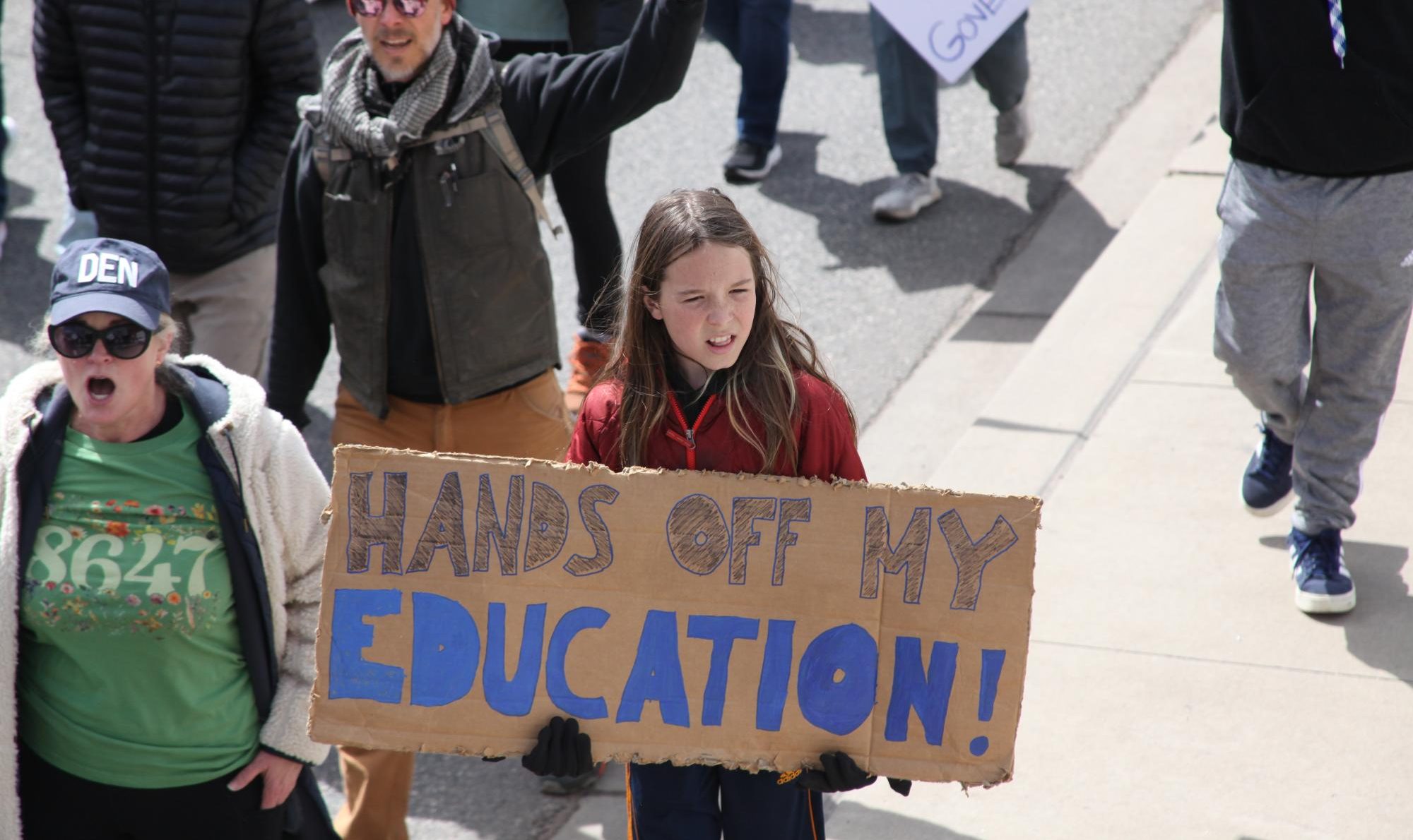 A young child holds a sign that reads “Hands Off My Education.” During Colorado’s ‘Hands Off’ protests against the Trump administration on April 5, many children could be seen protesting the actions being taken against the Department of Education. 
