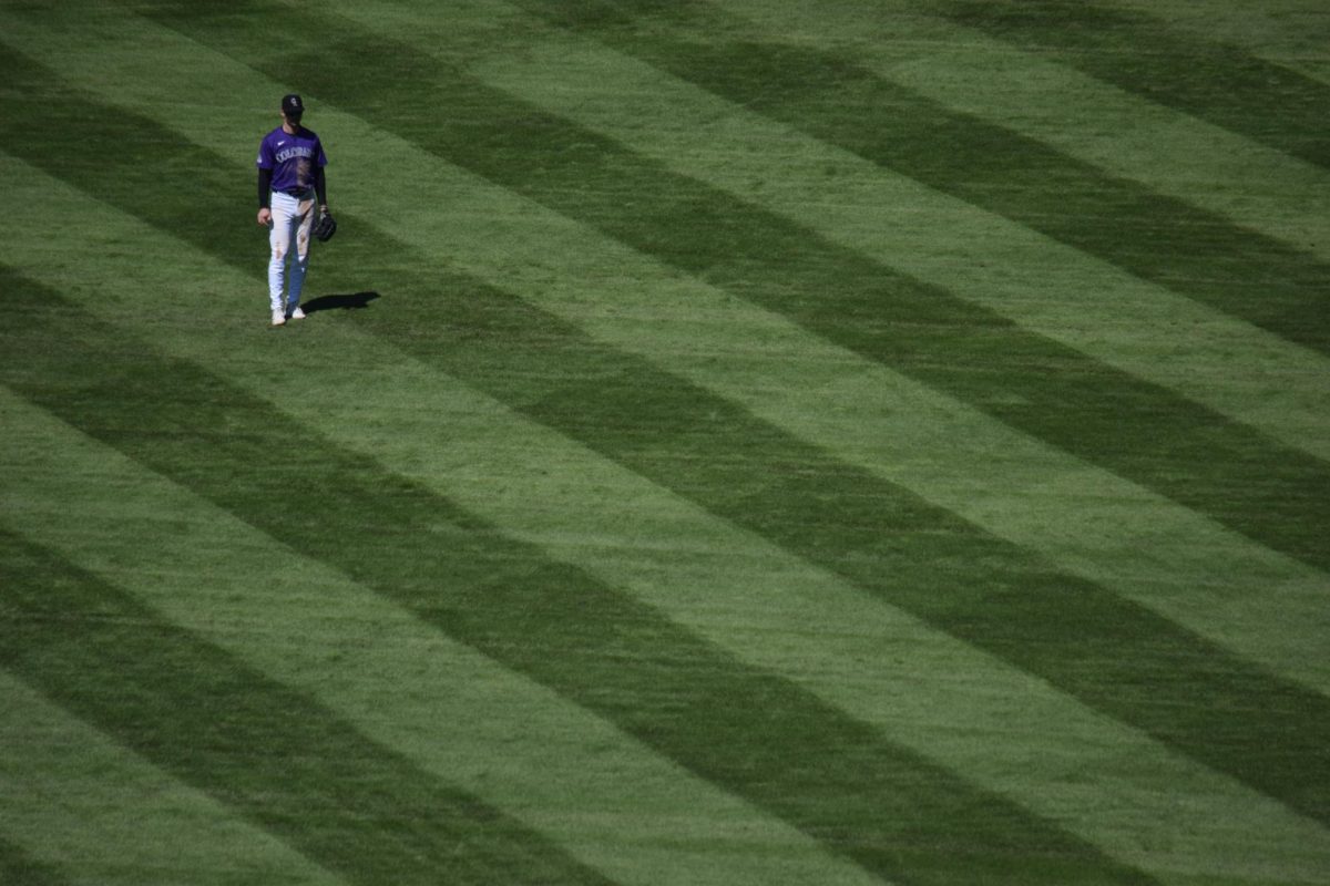 OUTFIELD: Colorado Rockies center fielder Brenton Doyle sets for a pitch while playing center field at Coors Field in a game in April last season. The field’s outfield is the largest in the league at 121,486 square feet. These types of unique hitting and fielding environments affect how we treat player accomplishments.
