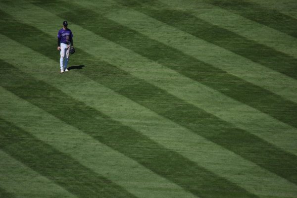 OUTFIELD: Colorado Rockies center fielder Brenton Doyle sets for a pitch while playing center field at Coors Field in a game in April last season. The field’s outfield is the largest in the league at 121,486 square feet. These types of unique hitting and fielding environments affect how we treat player accomplishments.
