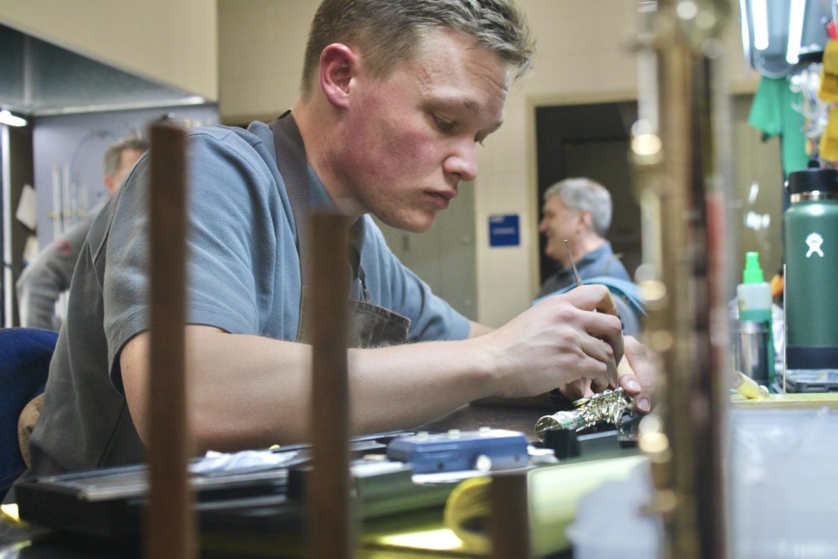 Technician Alan Davis fixes pad leaks in a flute on Nov. 25.