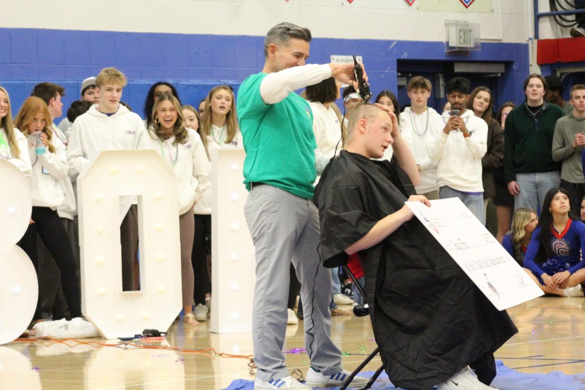 Principal Ryan Silva shaves Walter bald.