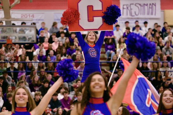During the Friday pep assembly, as poms perform in the foreground, a cheerleader is hoisted in the air, holding a giant C for "CCHS."